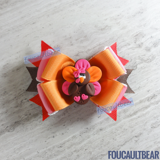 Foucaultbear's HANDMADE MULTI-LAYERED HAIR BOW CLIP with CLAY CENTERPIECE. Clay Mrs. Turkey. Handmade Polymer Clay Centerpiece. Grosgrain Ribbon. French Barrette Hair Clip for Ponytail or Pigtails. Adorable Fall Thanksgiving Mrs. Turkey Handmade centerpiece adorns this hair bow. Perfect for toddlers, preschoolers, kindergartners, elementary or even middle-schoolers for the coming Thanksgiving & Christmas holiday seasons. Can be worn year round should you desire to. Why not? 