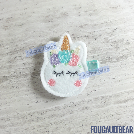 Foucaultbear's HANDMADE HAIR CLIPPIE. Pastel Unicorn. Embroidered Soft Felt. Partially Lined Alligator Hair Clip. Cute Pastel Unicorn Hair Clippie. Every little girl will fall in love with unicorns at some point in their young life. Perfect for toddlers, preschoolers, elementary-schoolers. Absolutely adorable on babies with enough hair to wear to wear it too. Makes for a great baby Shower gift. Definitely not your standard cliché shower gift. Introduce variety to the baby's otherwise boring wardrobe. 