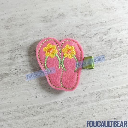 Foucaultbear's HANDMADE HAIR CLIPPIE. Summer Flip-Flops. Embroidered Soft Felt Centerpiece. Partially Lined Alligator Hair Clip. Summer Flip-Flop Thong Sandals Hair Clippie. Perfect for toddlers, preschoolers, elementary-schoolers. Absolutely adorable on babies with enough hair to wear it too. Makes for a great baby Shower gift. Definitely not your standard cliché shower gift. 