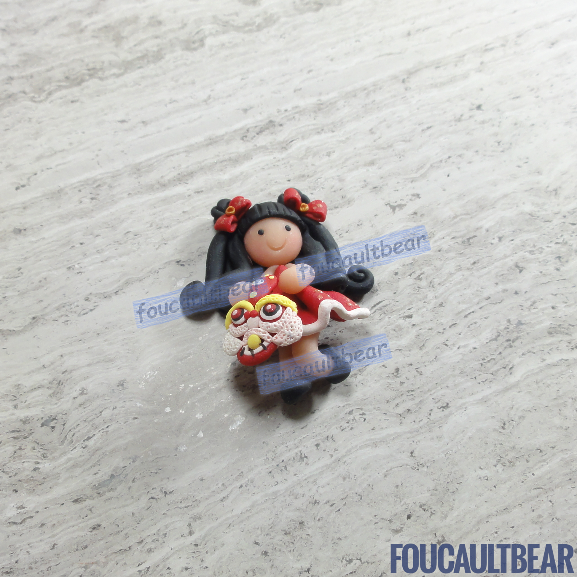 Foucaultbear's HANDMADE CLAY ART FLATBACK. Lunar Chinese New Year Girl (Black Hair) with Lion (Small). Handmade Polymer Clay Art. For Your Own Creative Use, such as on Hair Bow Barrette Clips, Picture Frames and Refrigerator Magnets. This small sized flatback clay Lunar Chinese New Year Girl (Black Hair) with Lion looks good as a hair centerpiece. Great for any of your art projects, too.